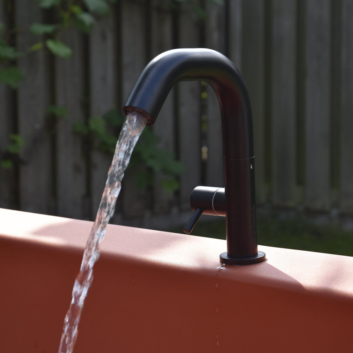 Matte Black Gardentub Tap filling a Terracotta Gardentub